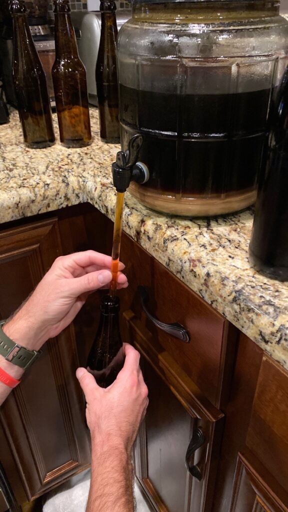 Adding the beer to the bottle in a controlled fashion