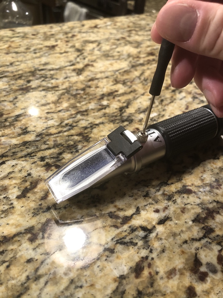 Calibrating refractometer with provided screwdriver