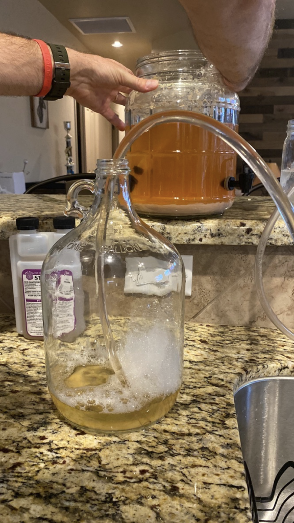 Mead slowly transferring to secondary fermentor